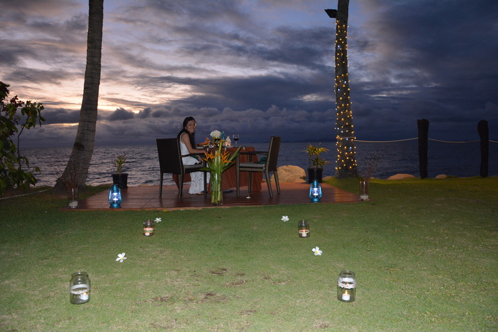 Set up of the Signature Dinner by the beach next to grass