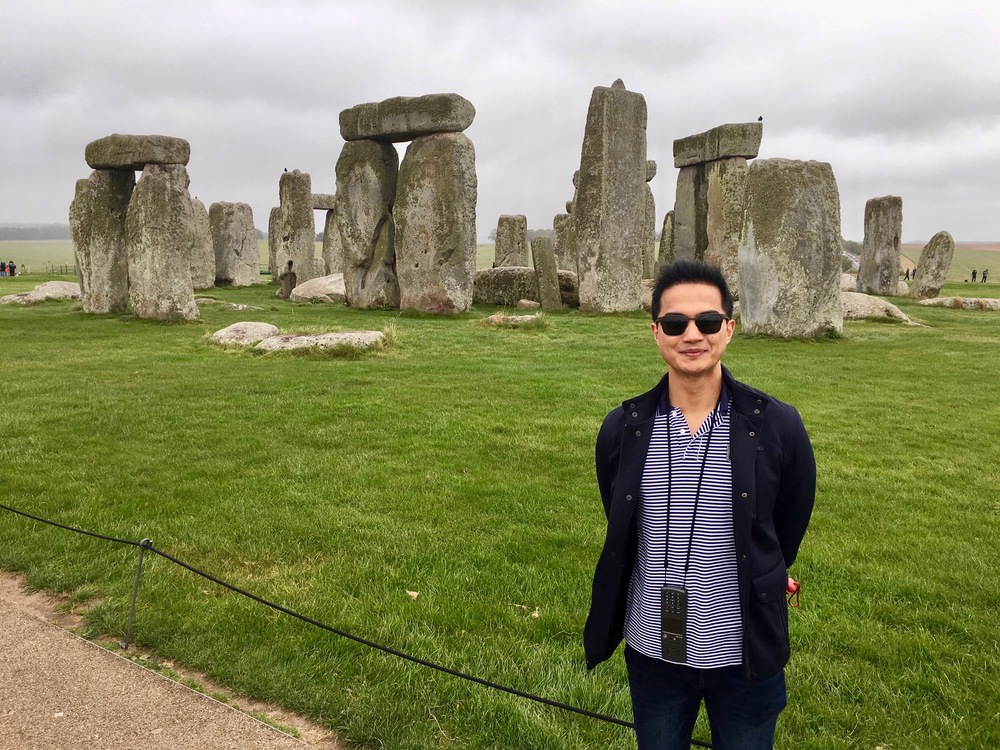 Francis standing in front of the Stonehenge, UK
