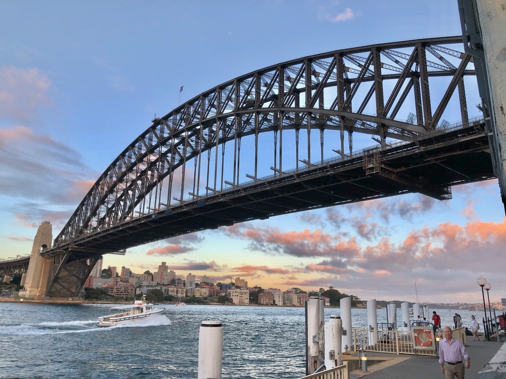 View of the harbour bridge with a sail boat underneath