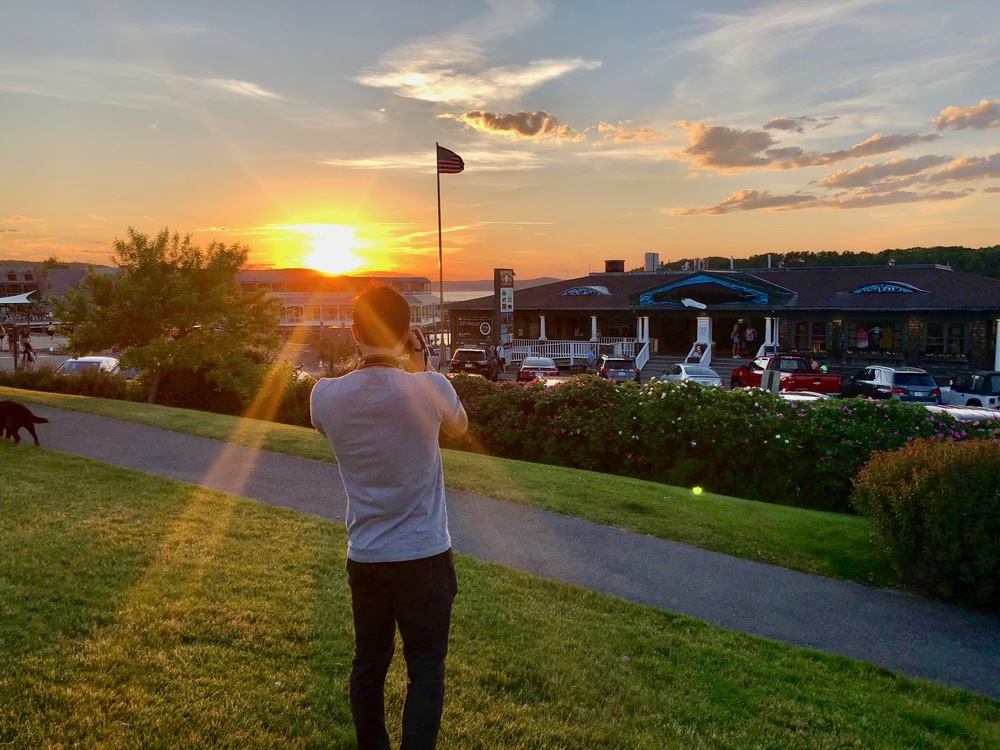 Francis taking a photo of the sunset in Agamont Park, Bar Harbor