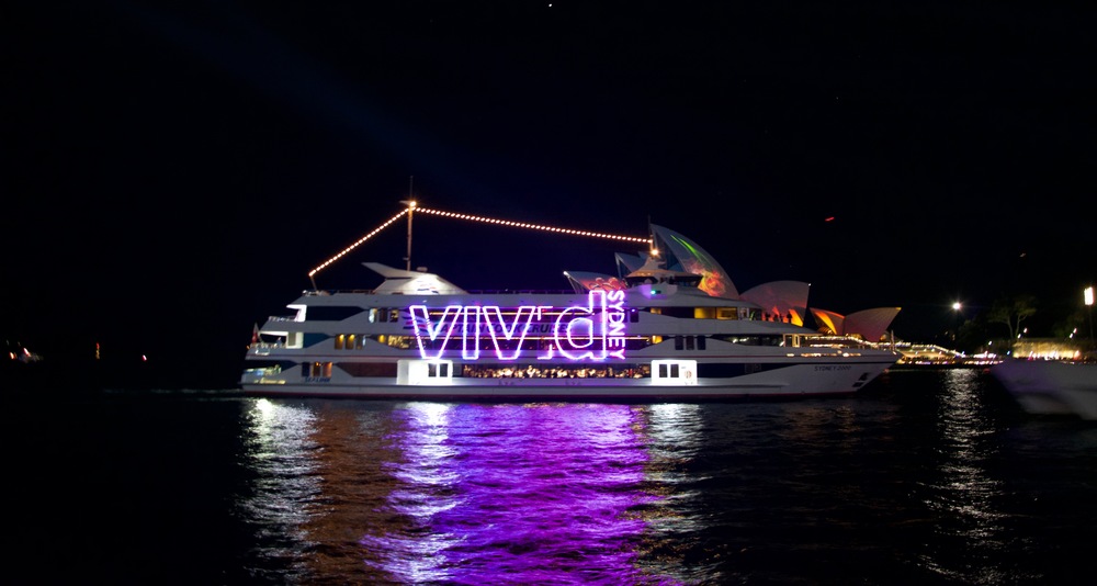 Cruise boat with Vivid Sydney lettering at night